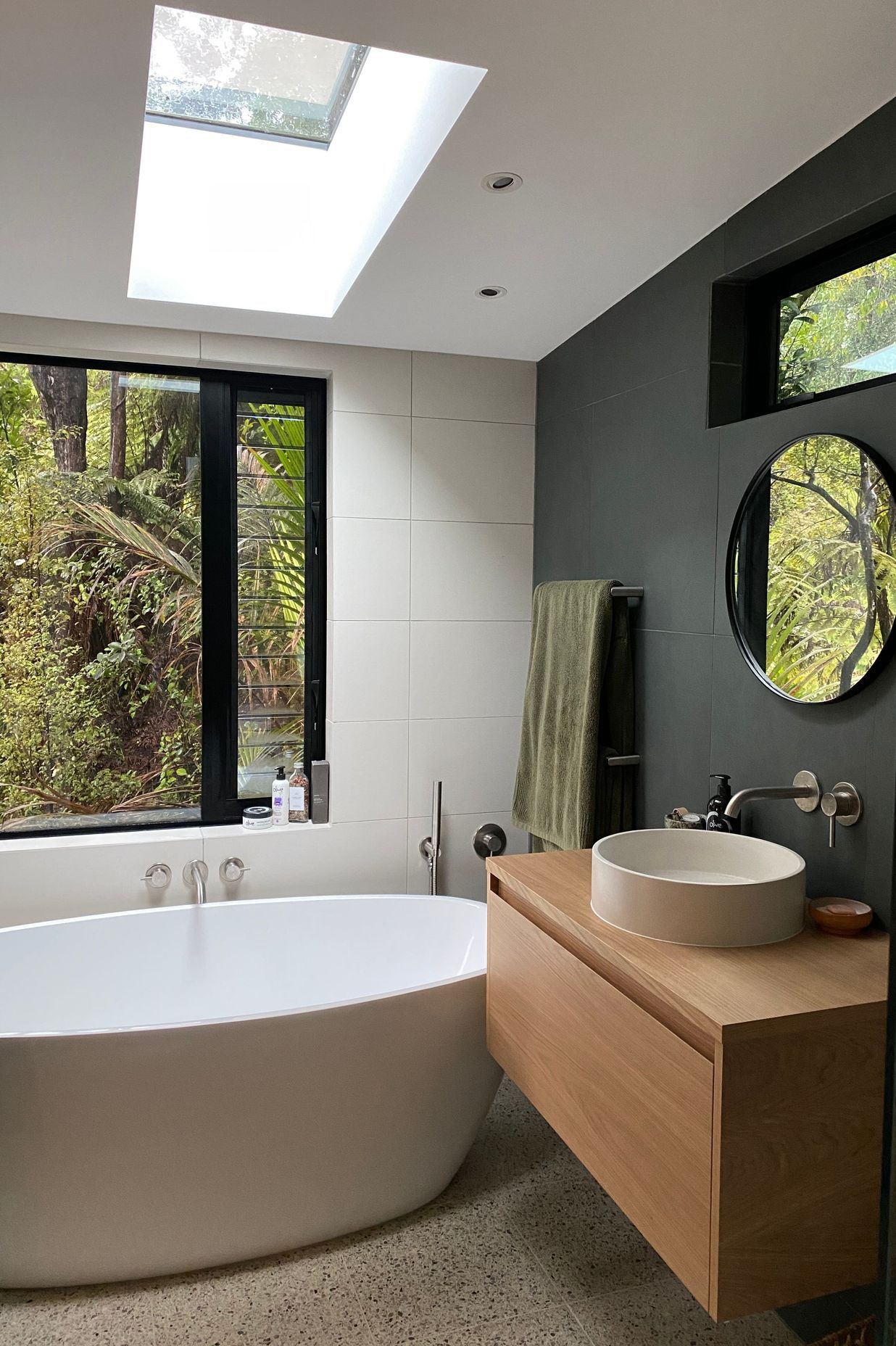 The floor under the bath cantilevers over the ground floor, in order to get that perfect spot for the bathtub, overlooking the bush.