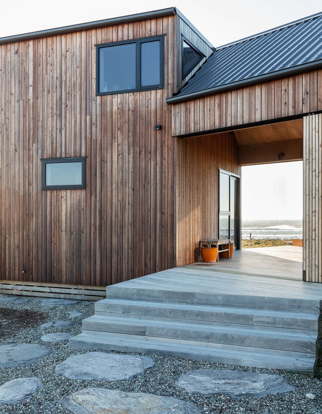 The breezeway connects the two dwellings while capturing the surrounding views. | Photographer: Sandra Henderson