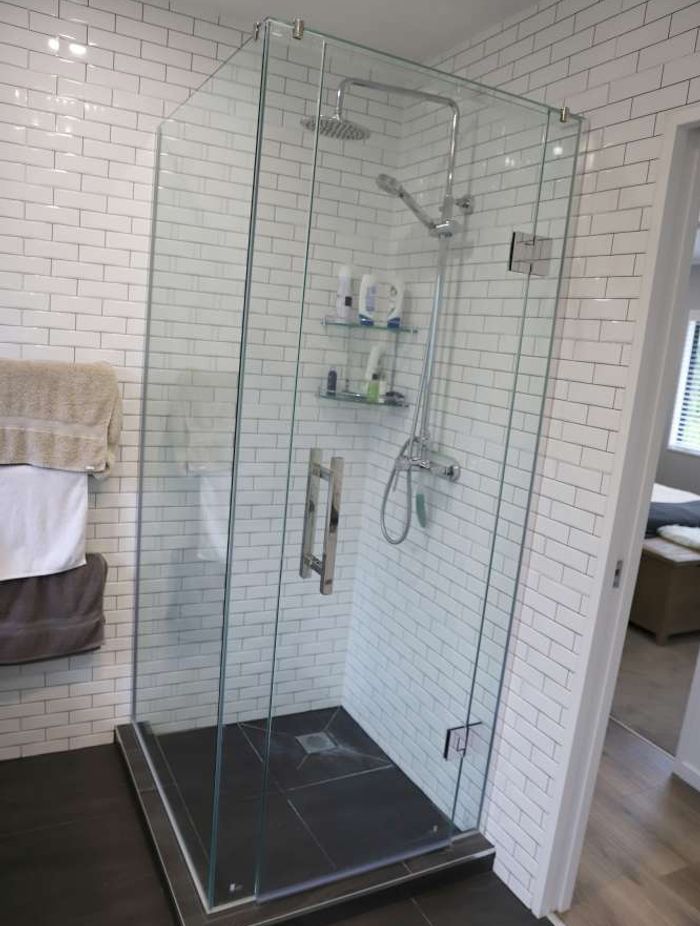 The installation of a pocket door enabled us to create this shower on the left side of the door.