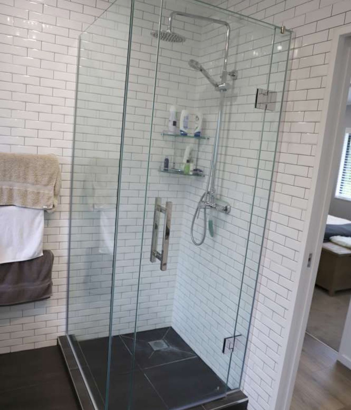 The installation of a pocket door enabled us to create this shower on the left side of the door.