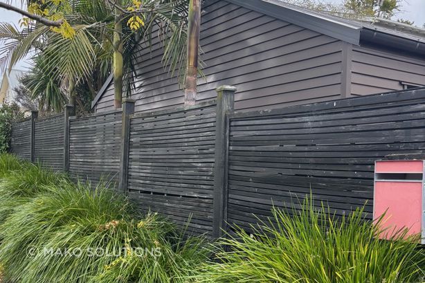 Old horizontal slat timber fence