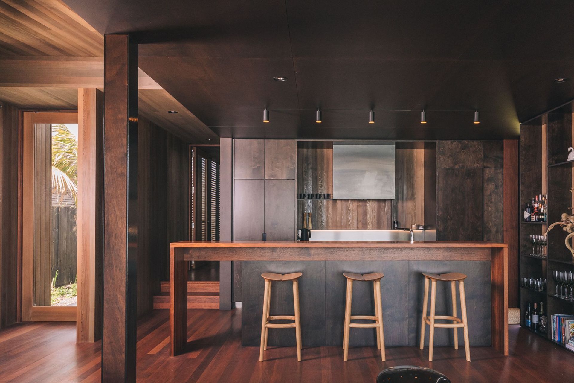 The kitchen is characterisied by deep, rich tones and a wealth of texture in the timbers.