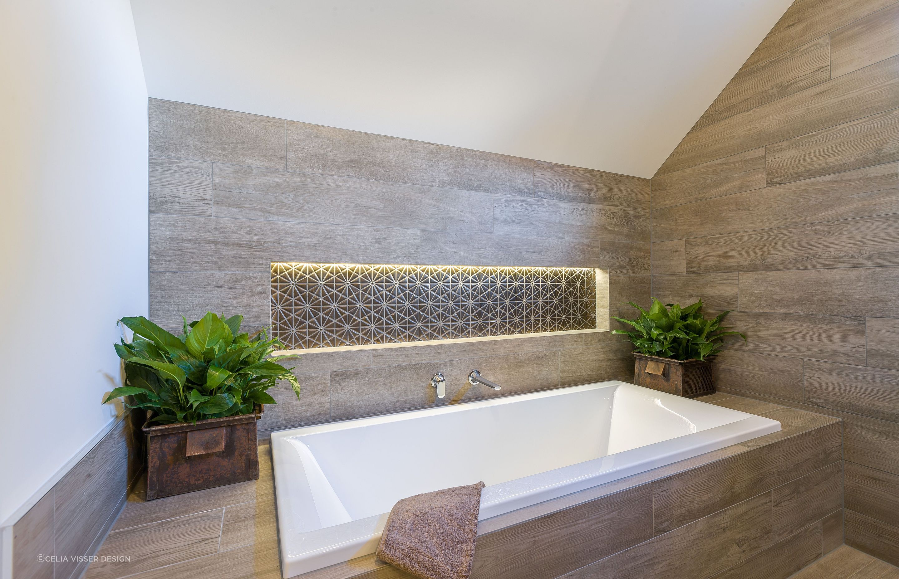The bathroom niche steals the show with superb lighting and tiling in this guest bathroom in Karaka.