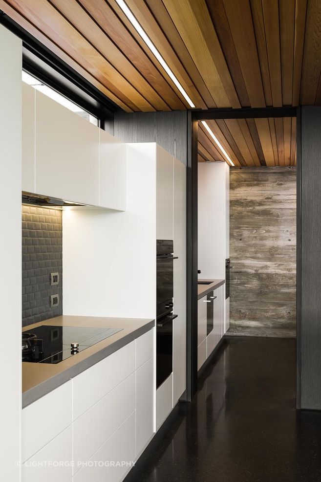 The simplicity of the scullery mimics the materiality of the kitchen and the overall simplicity of the building's design.