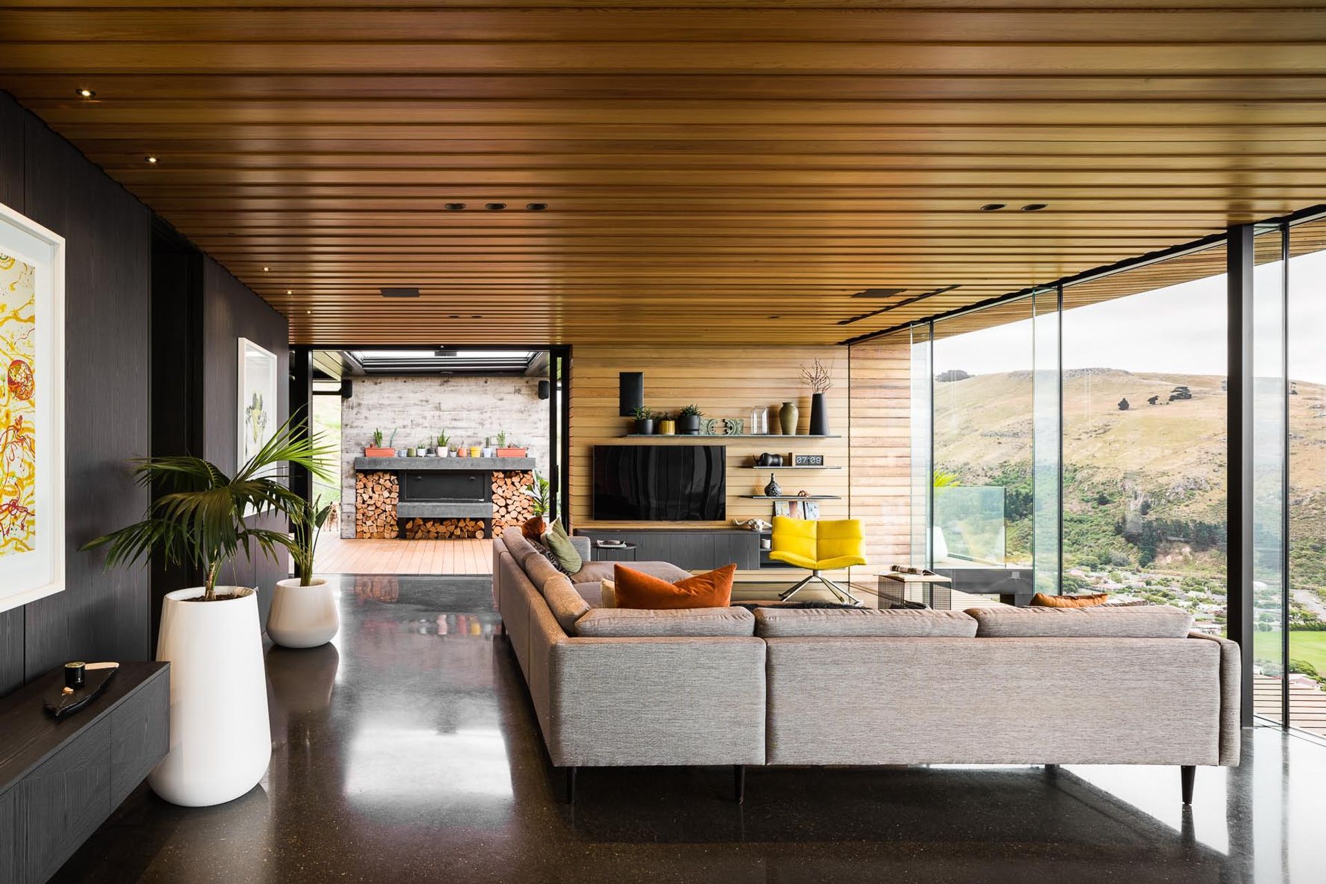 The open-plan living space leads directly to the outdoor living space through floor-to-ceiling sliders.