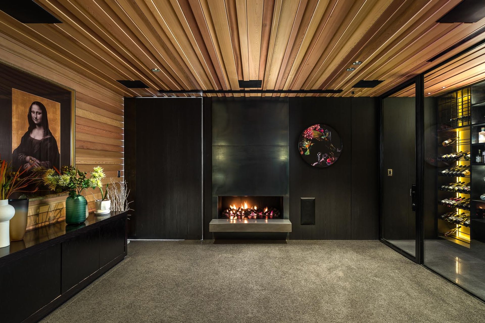 This TV lounge tucks in to the back of the living space and features a state-of-the-art wine storage system on one wall.