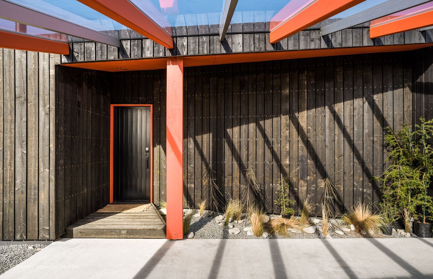 The entry door of Skylark Cabin in the Ben Ohau Range features a cohesive colour scheme with architectural elements of the home - Photography:  Lightforge Photography