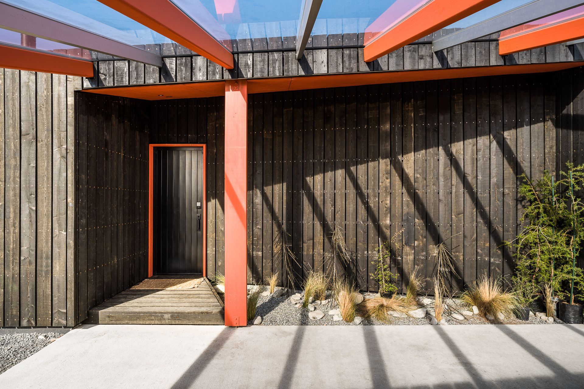The entry door of Skylark Cabin in the Ben Ohau Range features a cohesive colour scheme with architectural elements of the home - Photography: Lightforge Photography