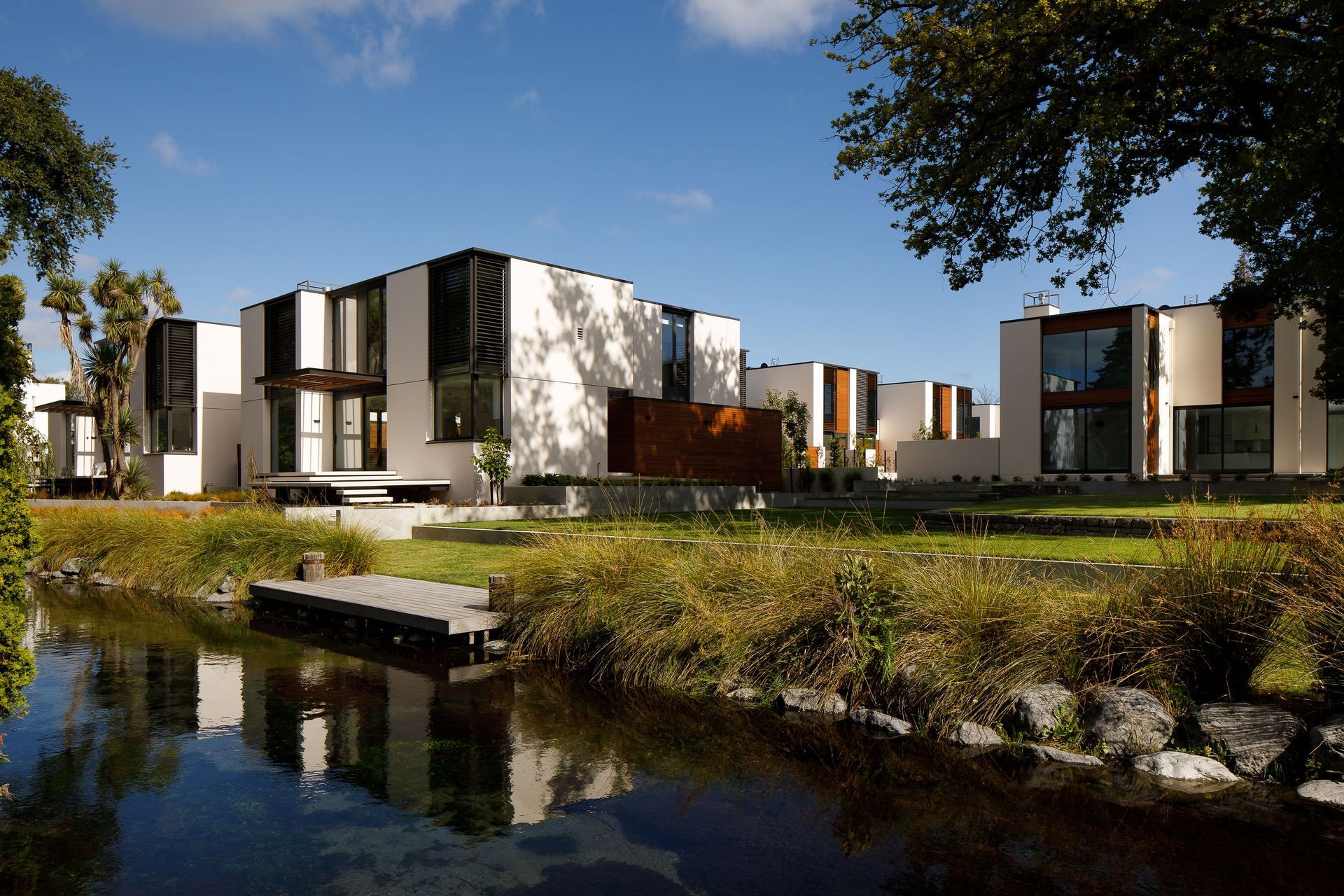 A community-minded housing development in Christchurch, Lintrathen Gardens by Sheppard &amp; Rout Architects hosts ten townhouses connected to a shared riverside green of the Avon River. Photograph by Jason Mann.