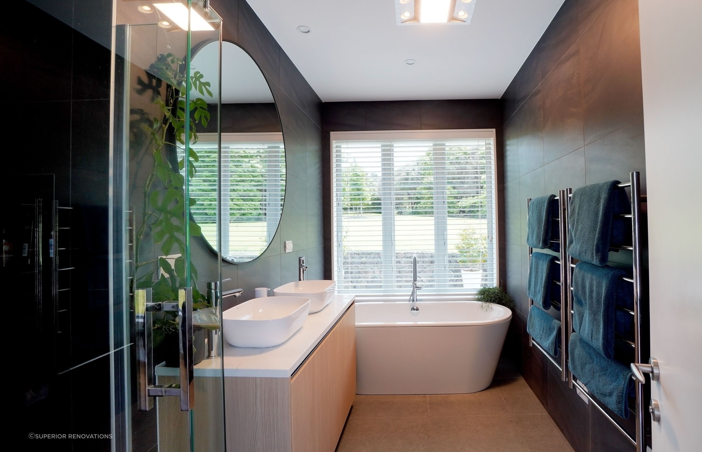 Dark accents used in small bathroom renovation in Redvale