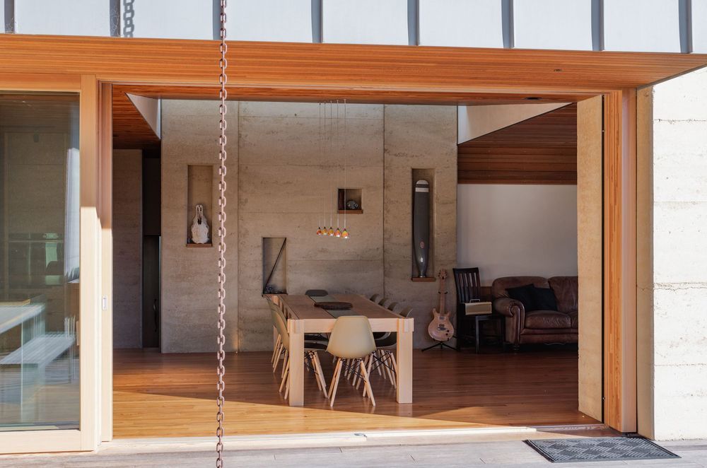 The materials were chosen for their various contributions to sustainability—whether its the thermal mass provided by the rammed earth or low-maintenance nature of the timbers and even the high-performance ratings of the glazing and insulation.