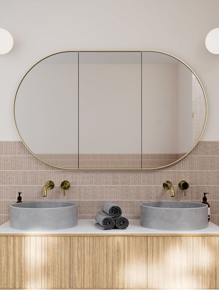 The brass satin frame matches the material of the taps. Featured product: Pill Mirror Cabinet