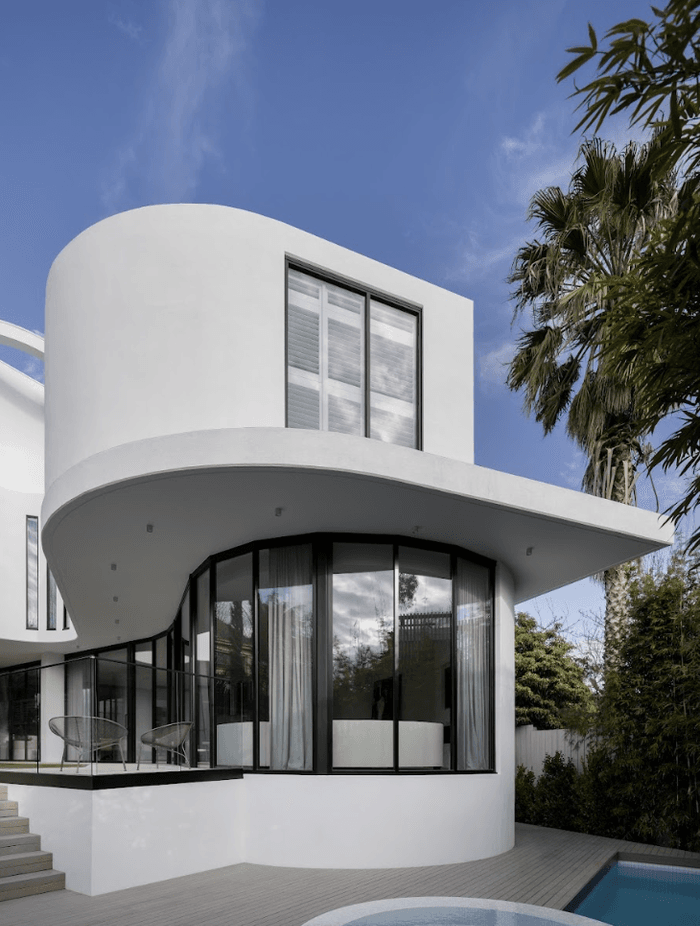 The concrete, formed and moulded into smooth, seamless curves, is coupled with expansive windows that capture light through different times of the day.