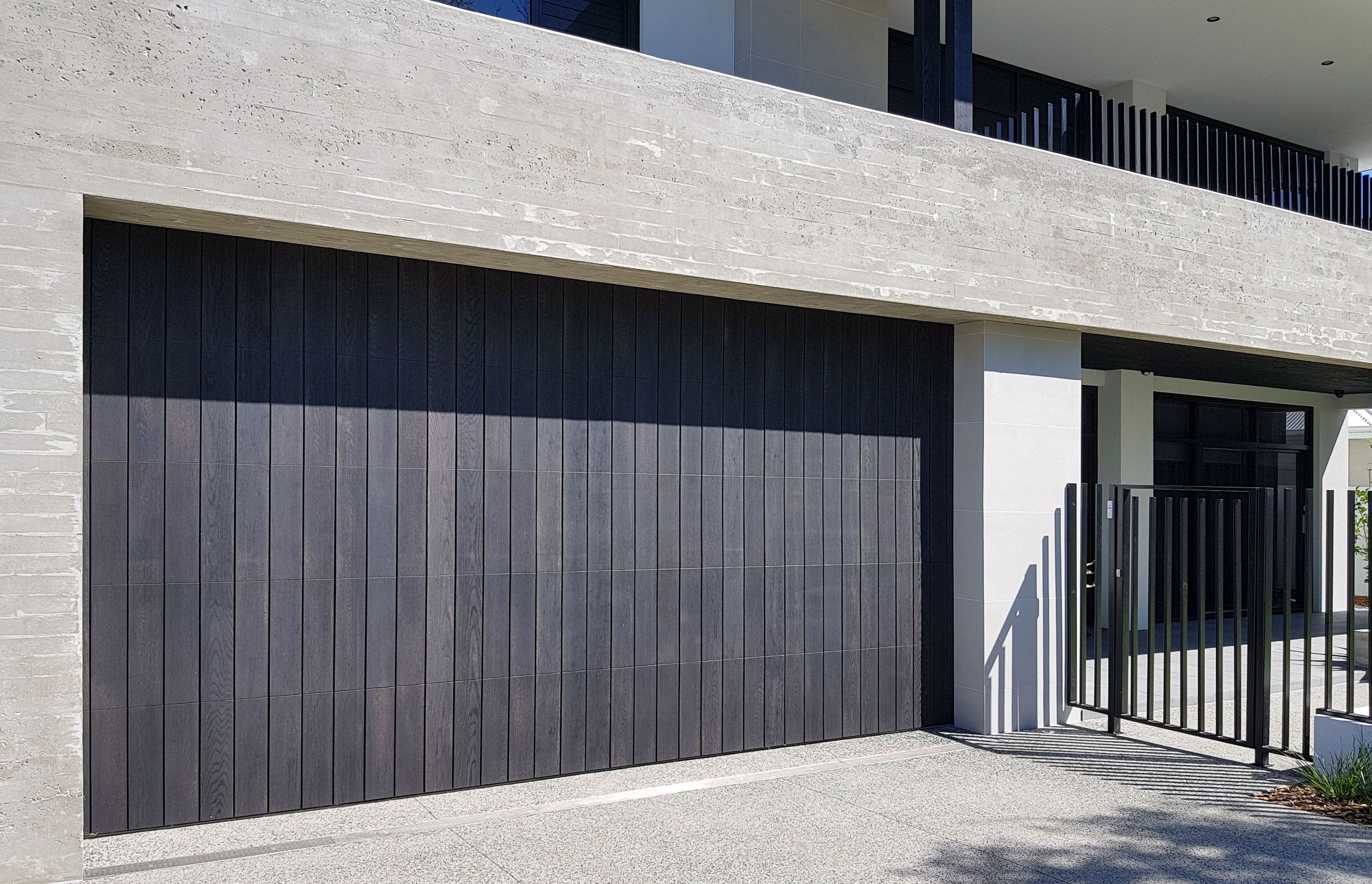Garage door featuring Millboard Charred Oak decking planks