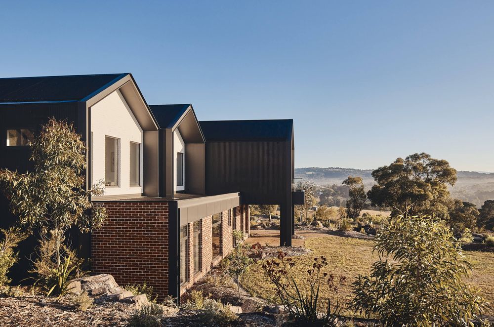 The home is surrounded by lush rolling shills and vegetation. Photography: Peter Bennetts