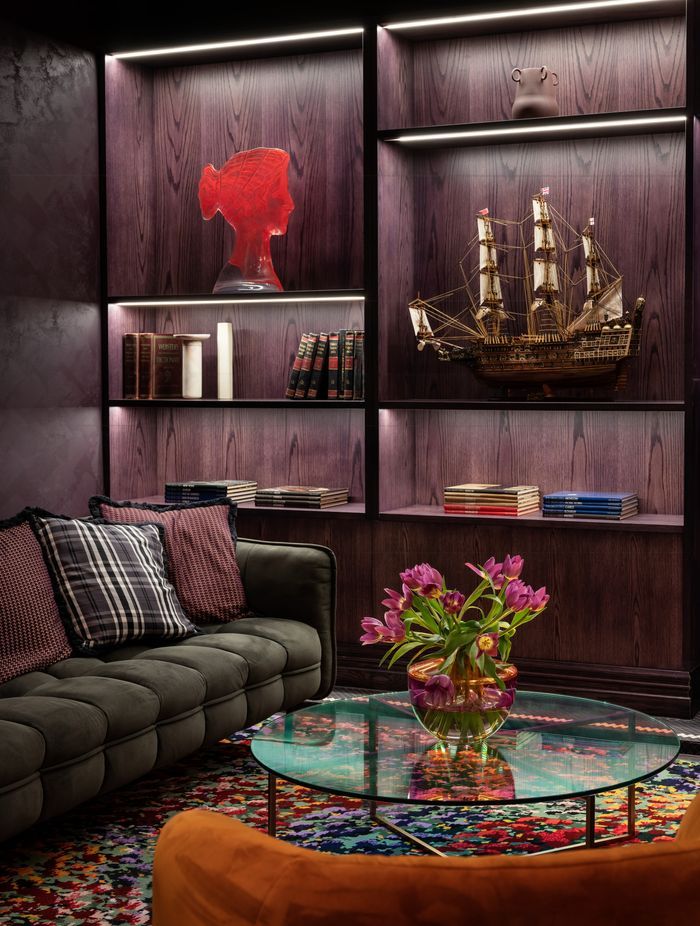 All the timber work in the bar area has been stained a bespoke purple hue. The cabinet of curios continues the theme of the Naumi woman and her sailor husband.