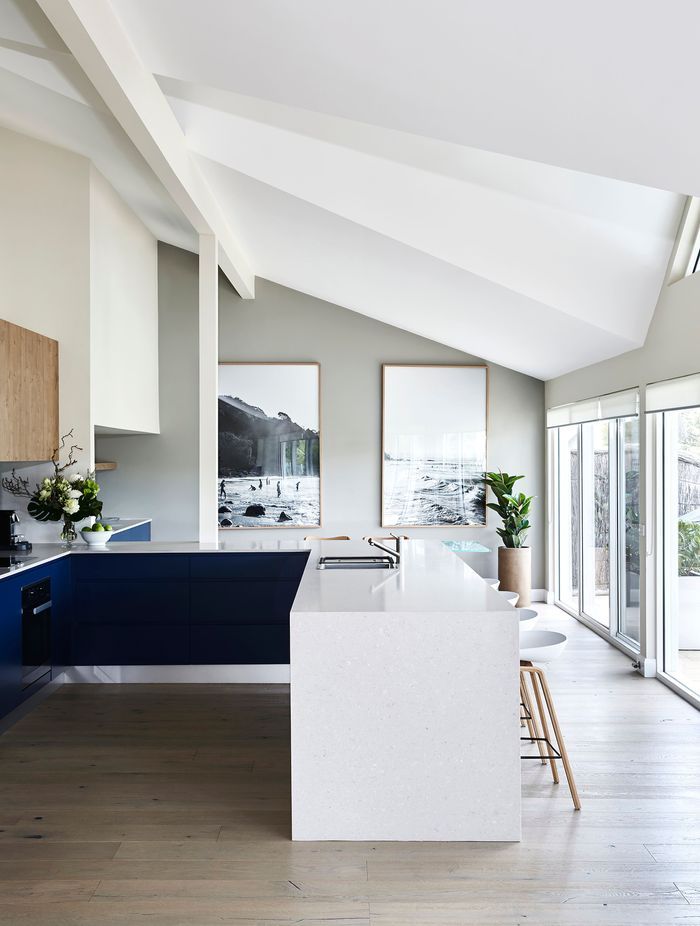 A kitchen bench featuring an in-built sink and seating options.
