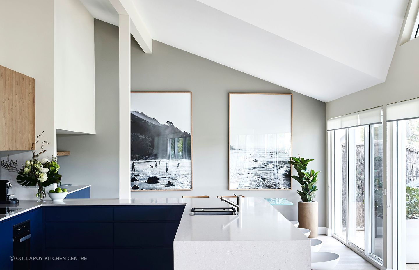 A kitchen bench featuring an in-built sink and seating options.
