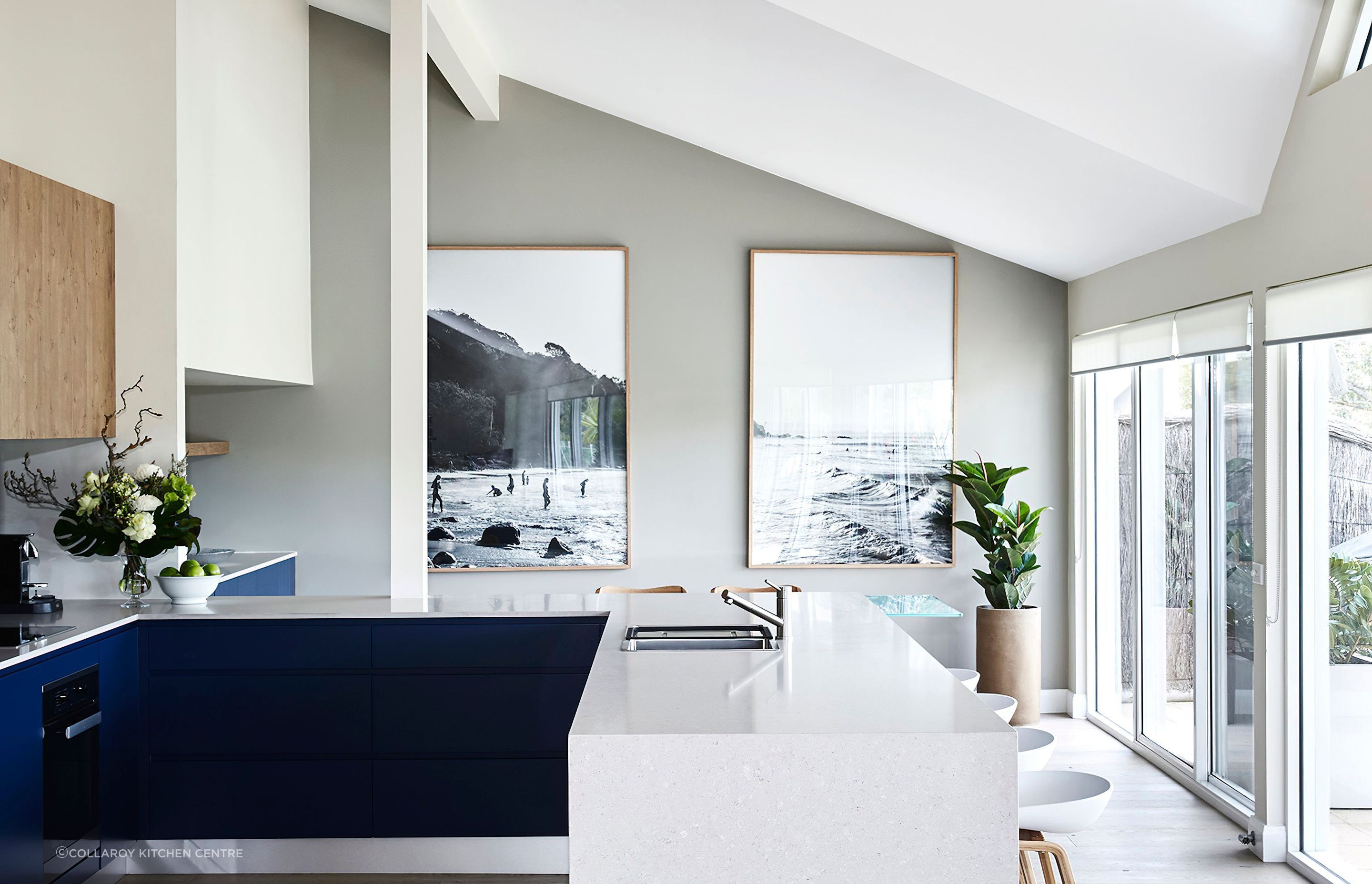 A kitchen bench featuring an in-built sink and seating options.
