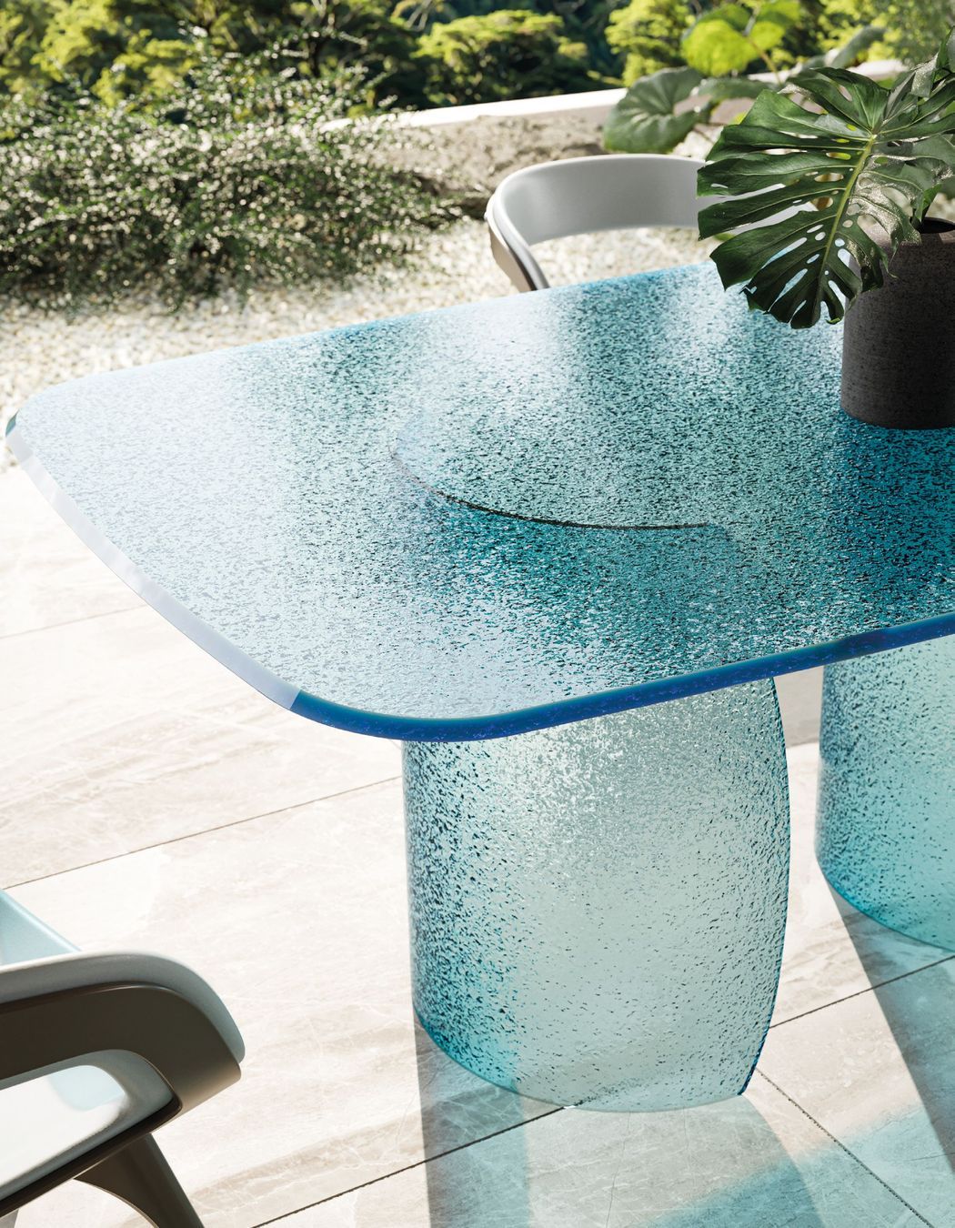 Petalo dining table featuring a base and top in Acqua glass in the colour blue