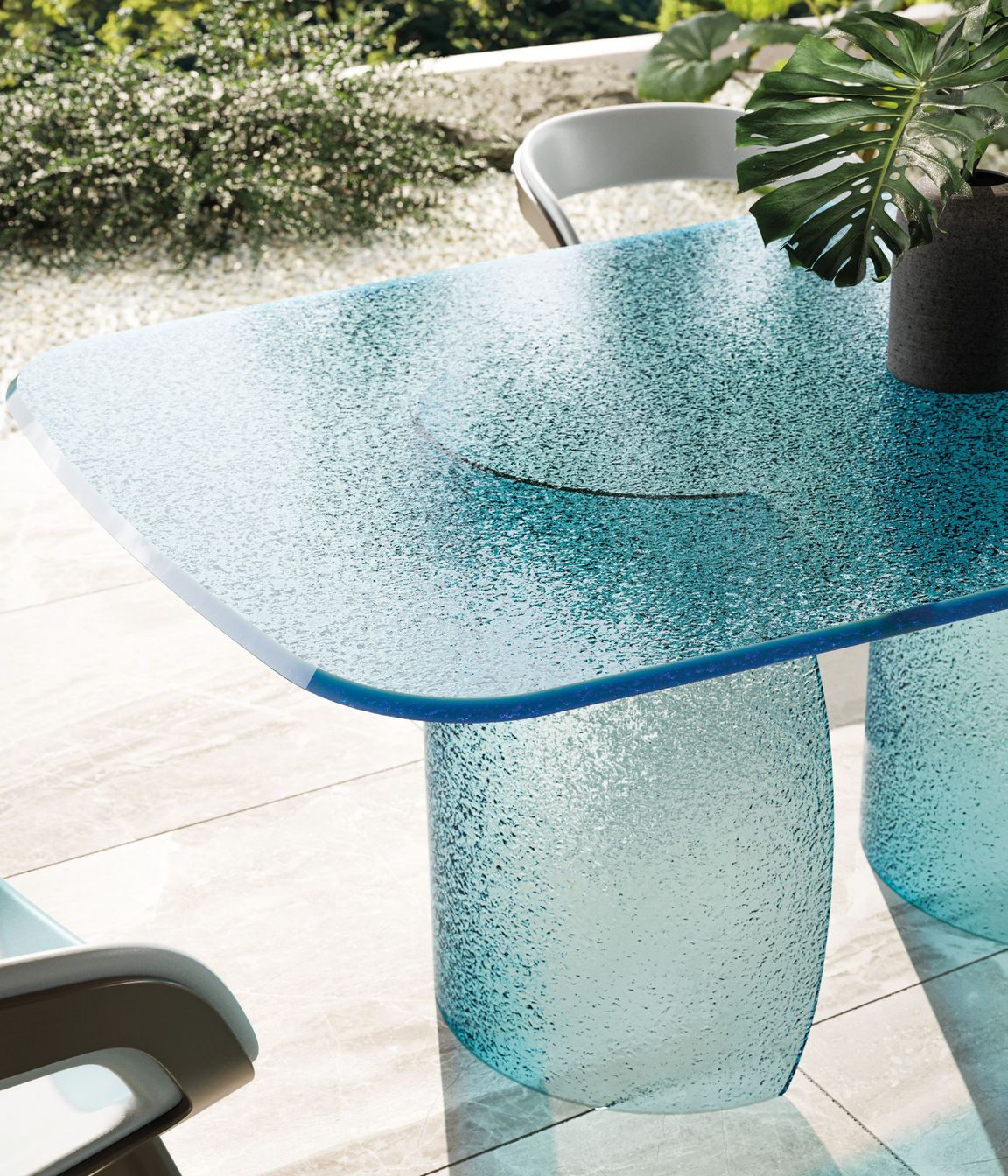 Petalo dining table featuring a base and top in Acqua glass in the colour blue
