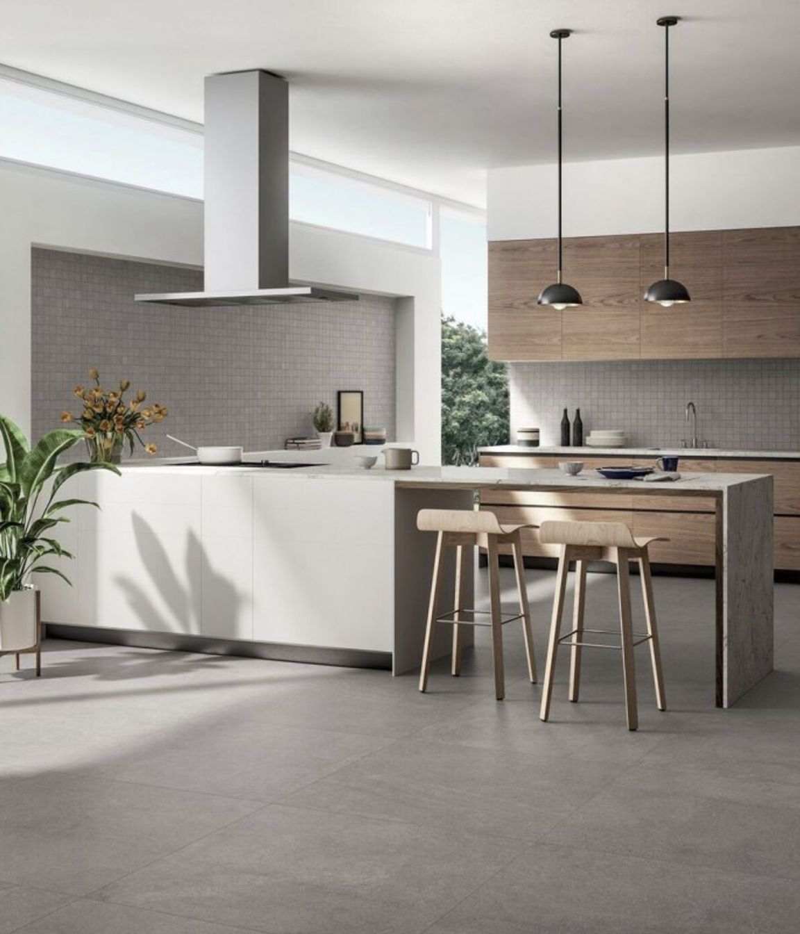 As seen in the picture, this kitchen flooring features large slabs of square tiles where the grouting is matched with the colour of the tile. This give the floor a a sort of continuity as the grout lines are hardly visible. (Tile Depot 2021)