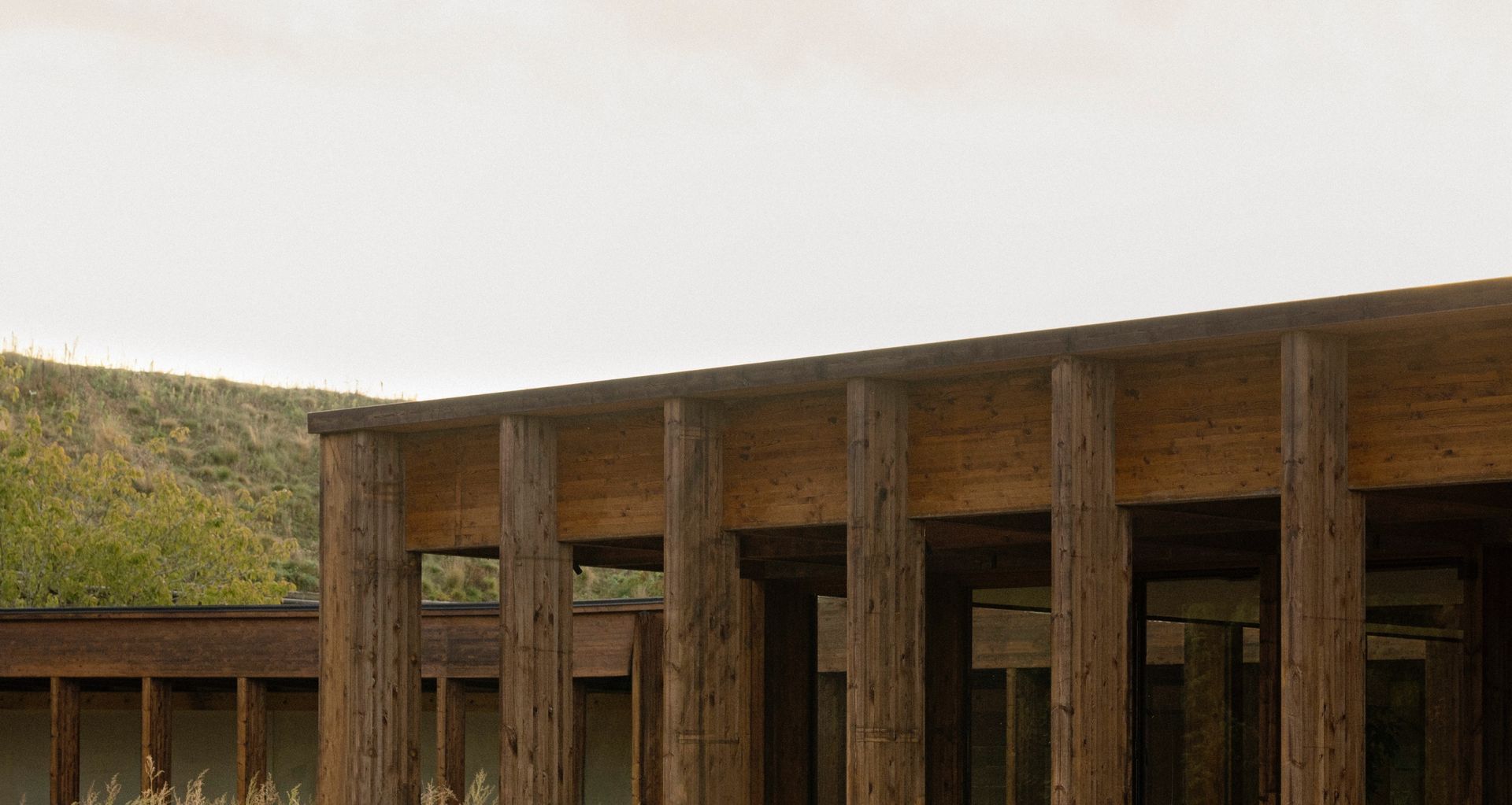 The timber structure follows the gentle contours of the landscape at Ästad Vingård. Photography by Jonas Bjerre-Poulsen.