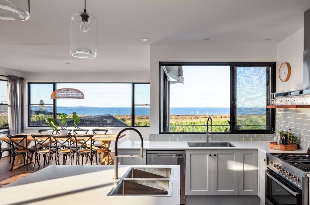 The kitchen and dining area intertwine nicely. Photographer: Shaw Photography.