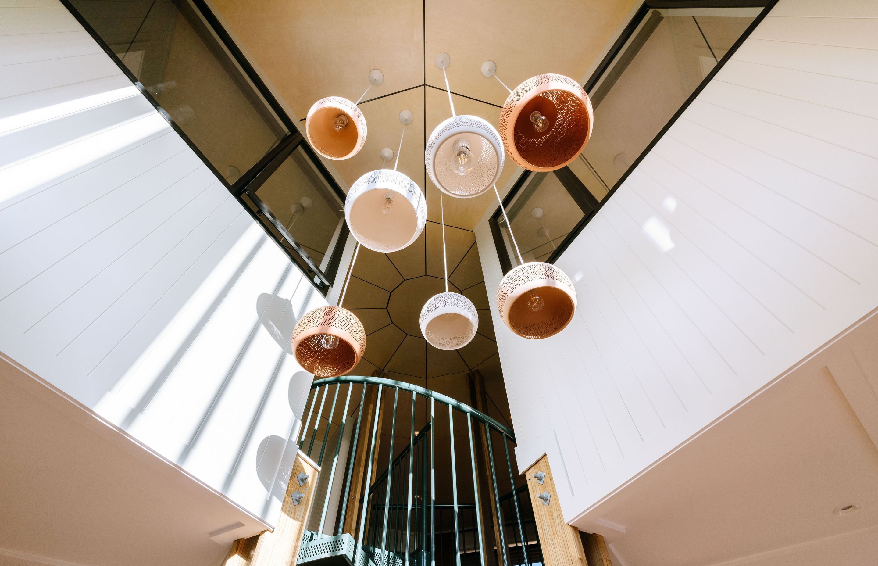 Feature lighting hangs above the main entrance, drawing your eyes to the upper level.