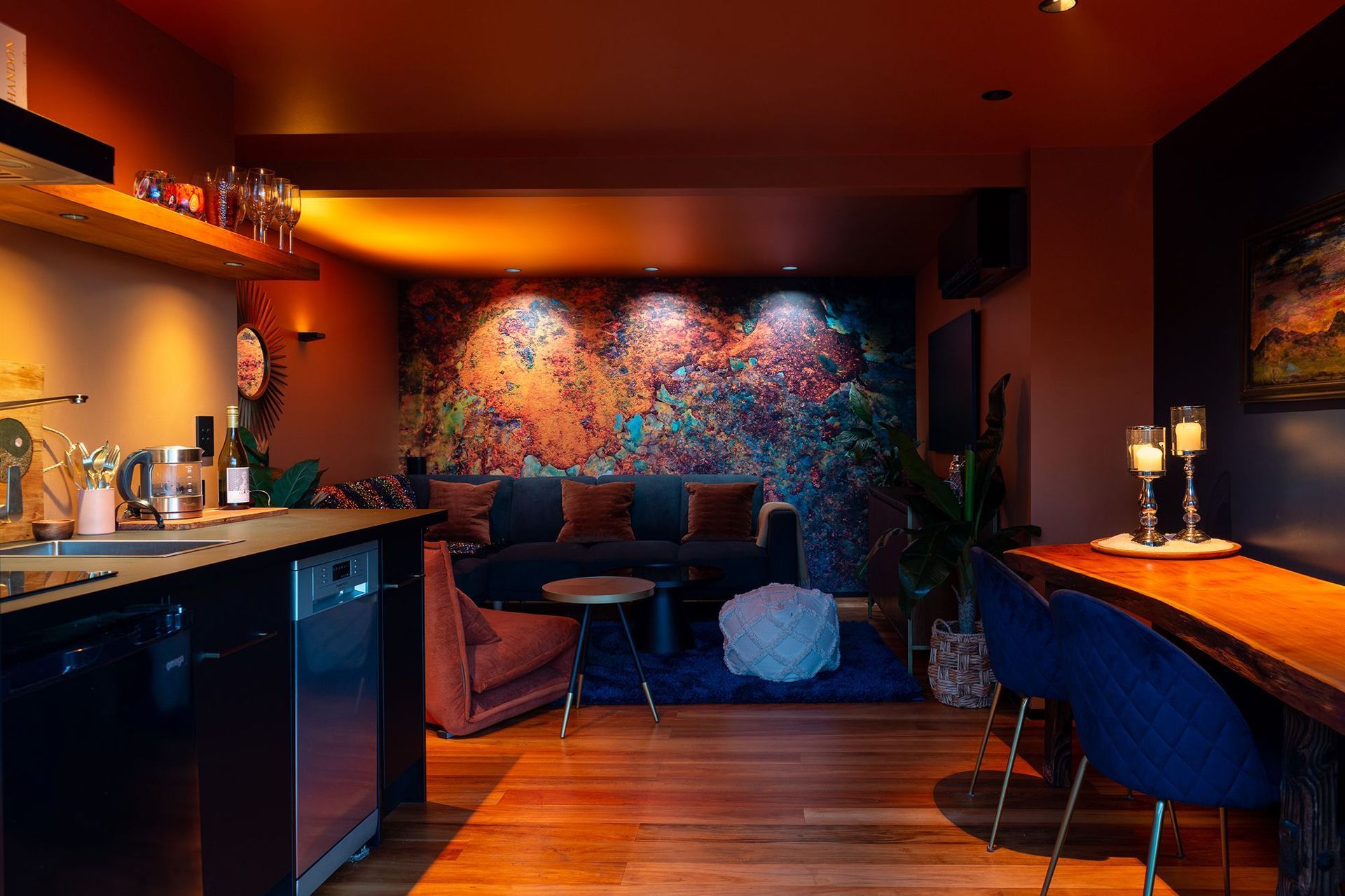 Abstract mural wall, illuminated with a variety of colour temperatures to highlight different colour ranges in the artwork, ranging from 1800K on the left, to 3000K in the centre, and finally 4000k on the right. Product: Switch Lighting ZELA Offset Deep Tilt SLDL251T