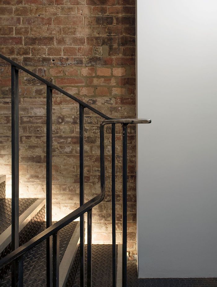 Darkarts Studio used lighting details to accent the junction between old and new in this renovated property.