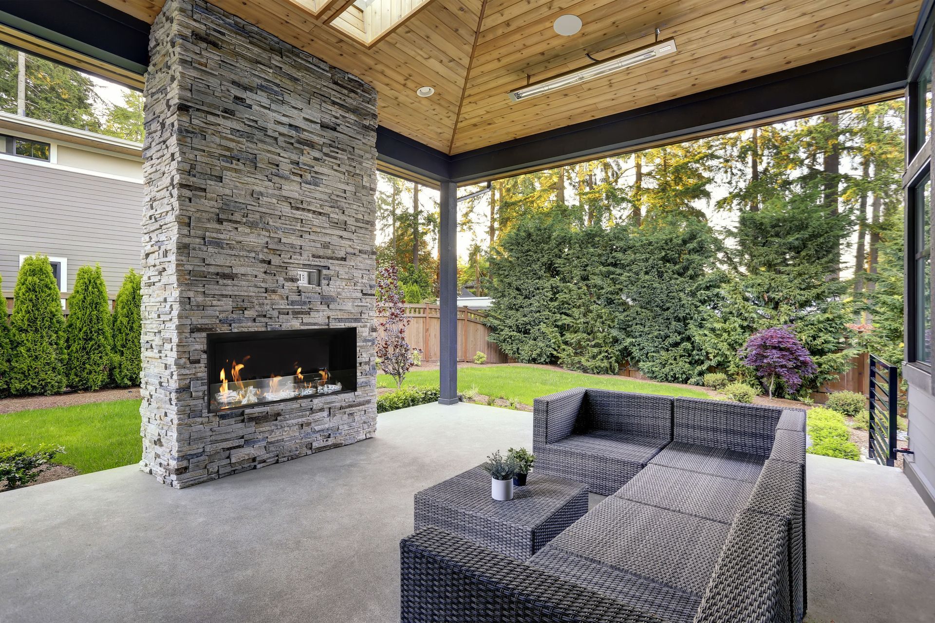 Complete an outdoor room with a fireplace that seamlessly fits with the existing design