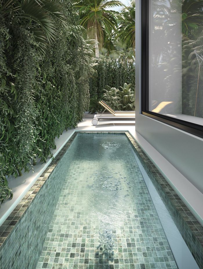 Tiles in shades of grey, brown and stone help create the visual effect of crystal-clear water in this swimming pool.