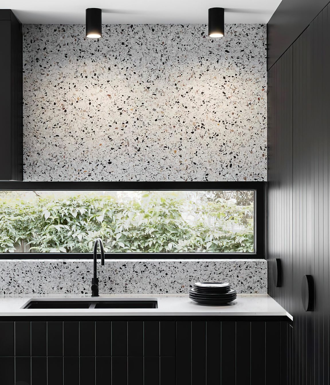 Tiles that feature a bold range of colours or patterns can sometimes feel like a challenge to pair with other materials! A great way to create a sense of cohesion and balance in your colour palette while incorporating pattern tiles is to pick out a single colour from your chosen tile and match this in other areas of your design scheme. This luxurious kitchen for example pairs terrazzo tiles with a black speckled pattern with black kitchen cabinets to create a harmonious look.