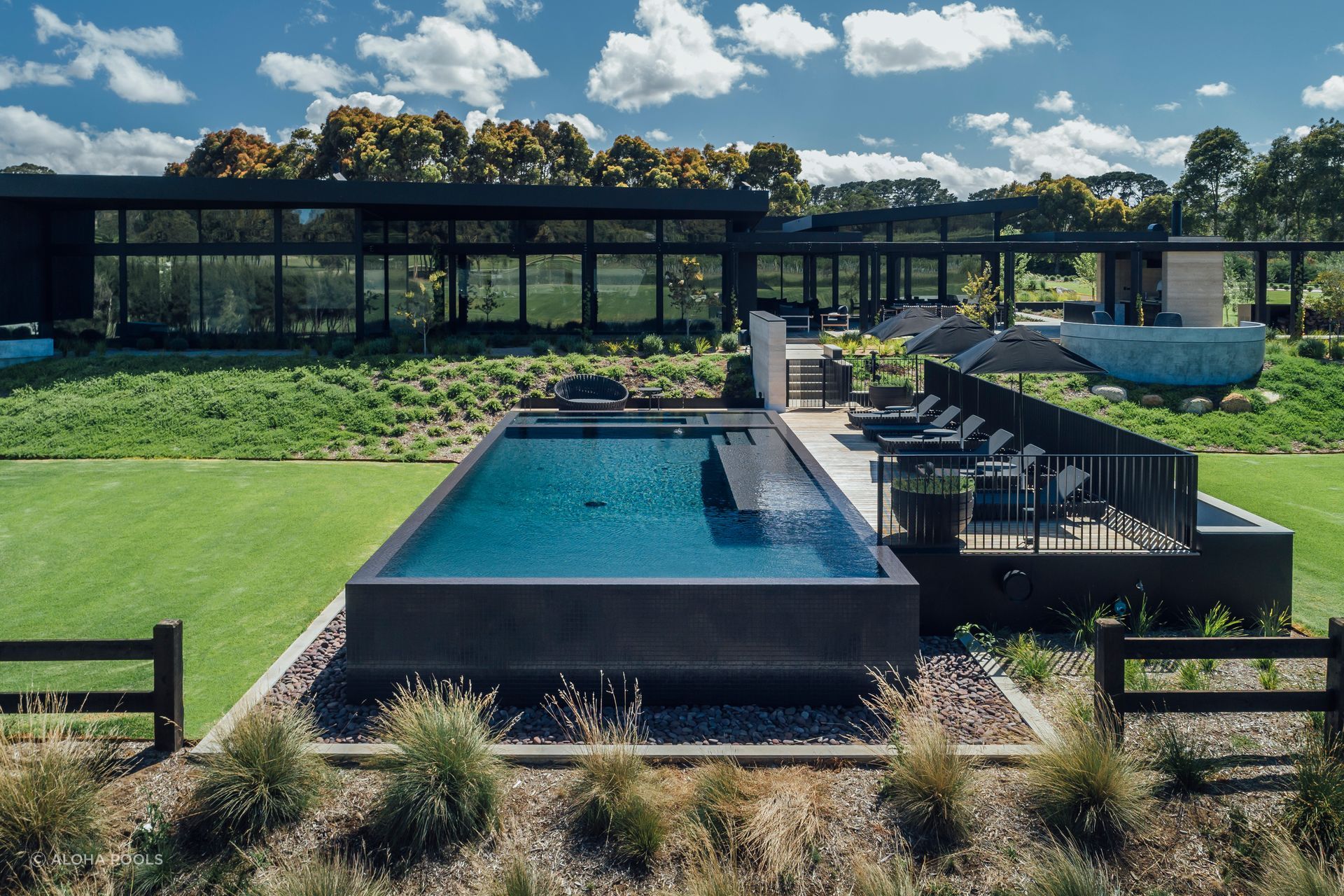 The deck fencing protects the deck and pool while keeping both private. Featured project: Perry Luxury Pool.