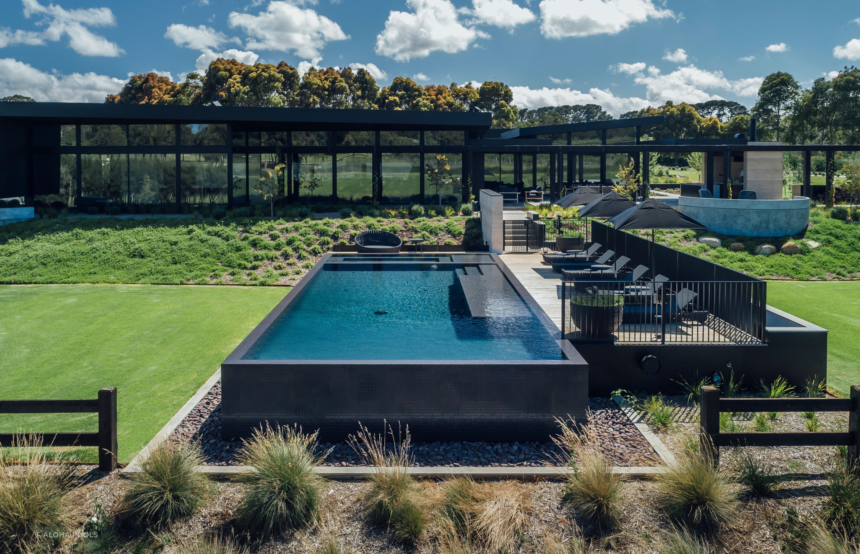 The deck fencing protects the deck and pool while keeping both private. Featured project: Perry Luxury Pool.