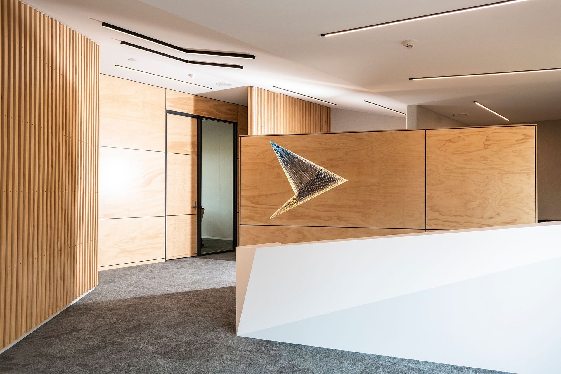 Tavolo Coronet was selected for its elegant and warm white colour profile and the surface left with a matte finish to perfectly complement the timber accents in this newly refurbished office space.