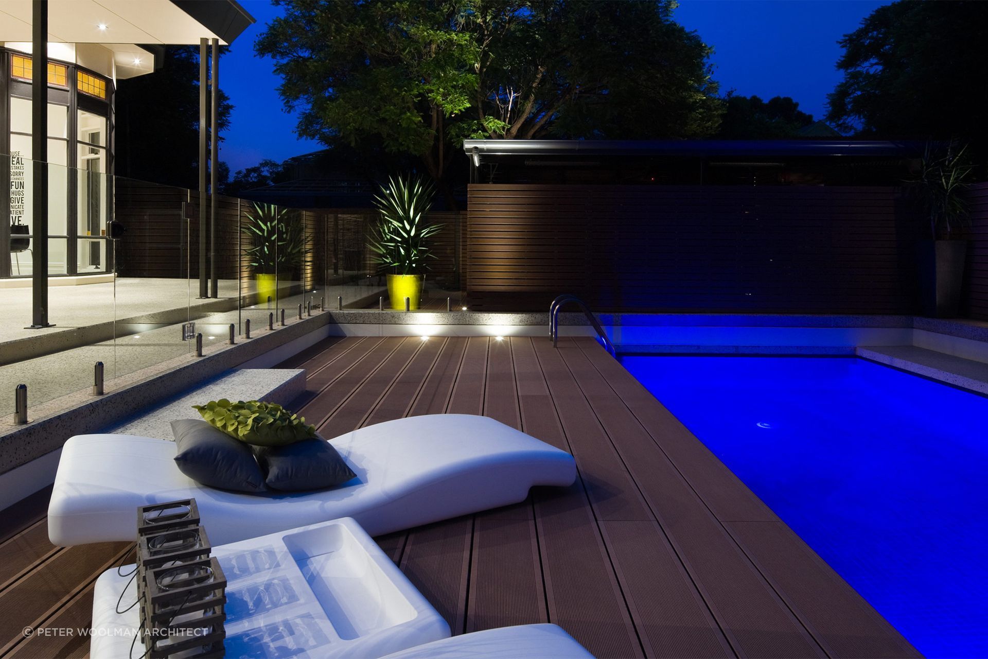 The wooden fencing to the right-hand side of the pool protects the far side, while a frameless glass fence protects the deck. Featured project: The Pool Deck Unley.