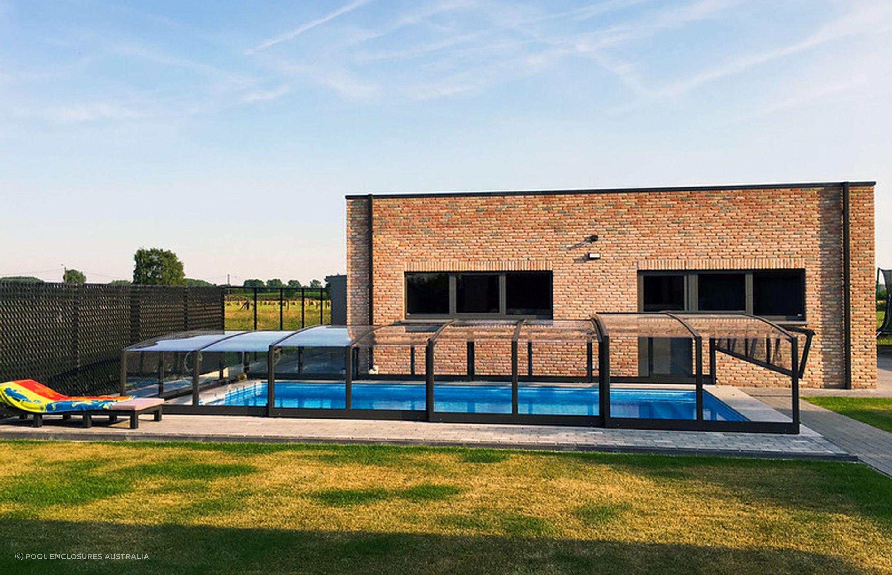 A pool enclosure is an innovative alternative to a traditional pool fence. Featured product: Viva Pool Enclosure.