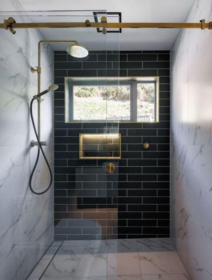 The collaboration of metal fixtures and cool-toned colours brings the home's modern and Victorian mixed aesthetic to the bathroom