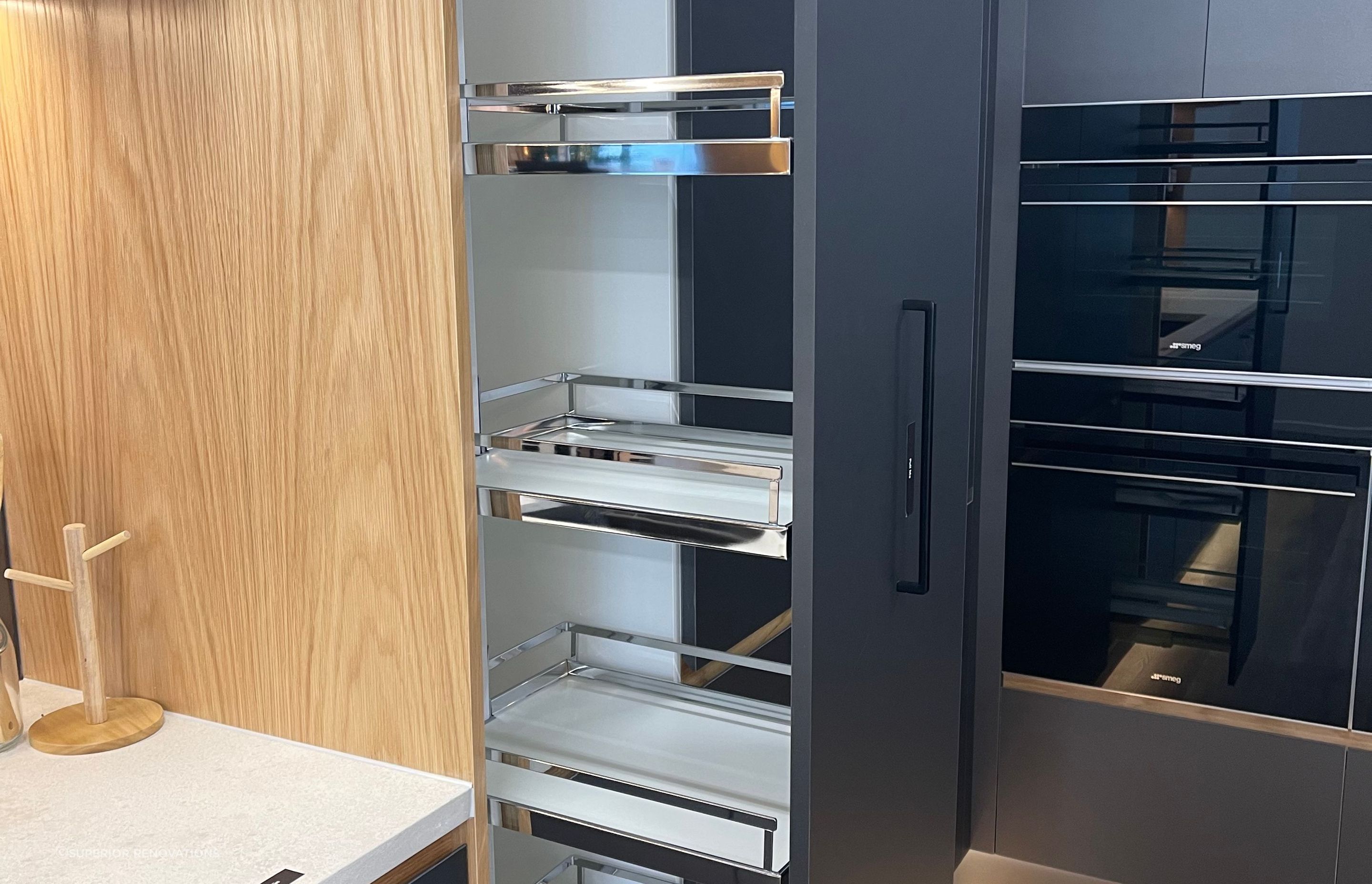 Pull out pantry with in-built shelves makes it easy for you to clearly see all the stored items and retrieve them. – This pantry can be seen in our matte black kitchen display in our Kitchen showroom in Auckland.