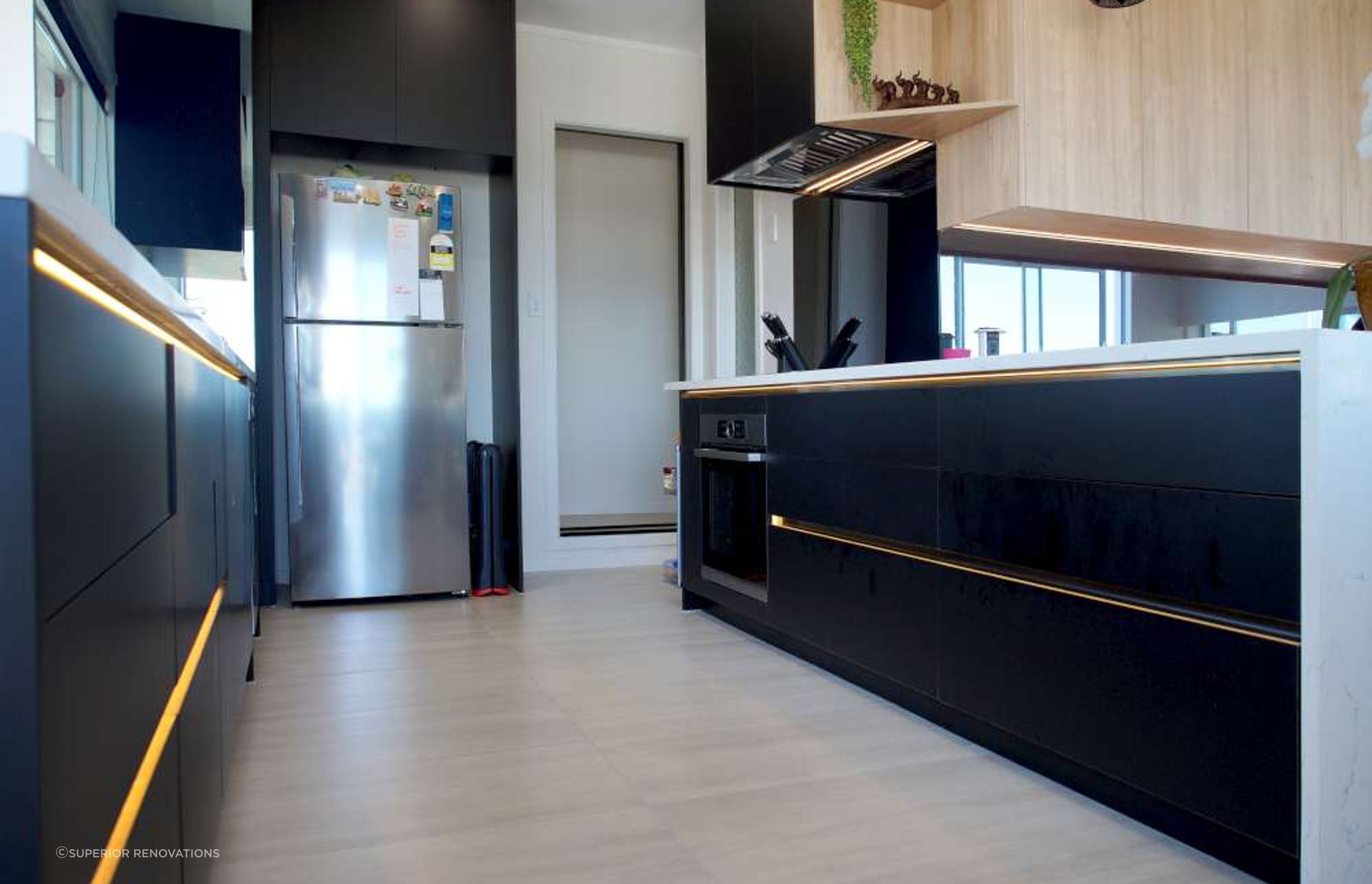 Kitchen renovation in West Auckland Massey - Our client in Massey wanted black cabinets against white to give a luxurious feel to his kitchen. LED lights were also installed under the cabinet handles to add to the glamour of the kitchen.