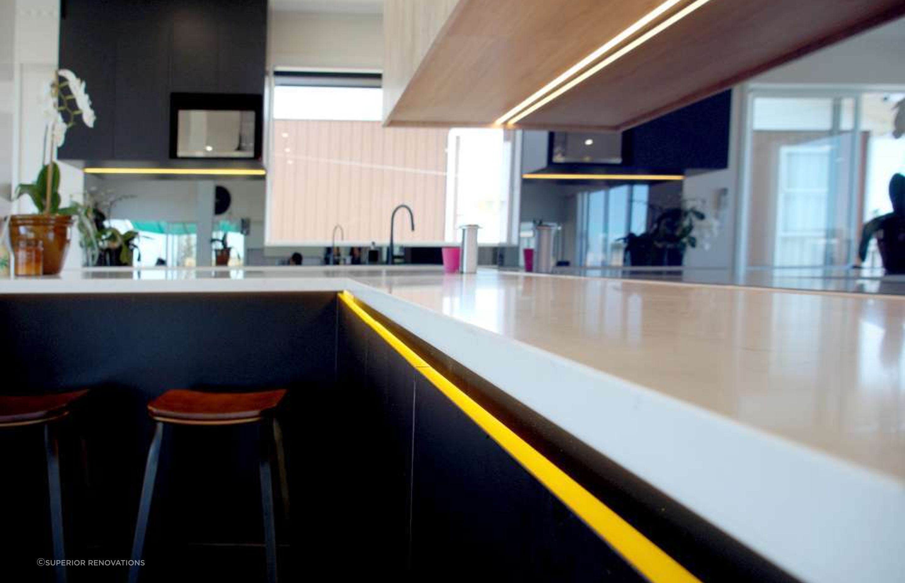 Kitchen renovation in Massey: Kitchen island extending into the living room space to double as a bar that can be used for entertaining.