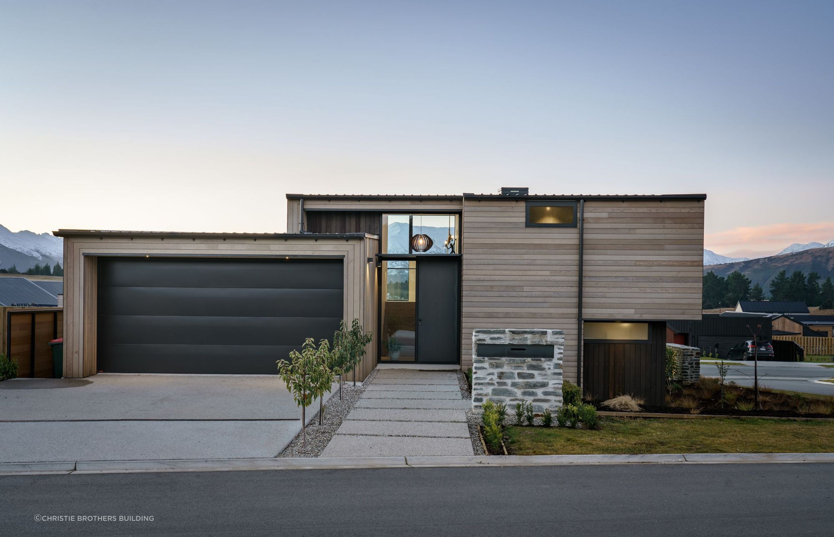 Large form pavers provide the perfect platform for entry in this modern suburban home in Wanaka - Photography: Simon Larkin