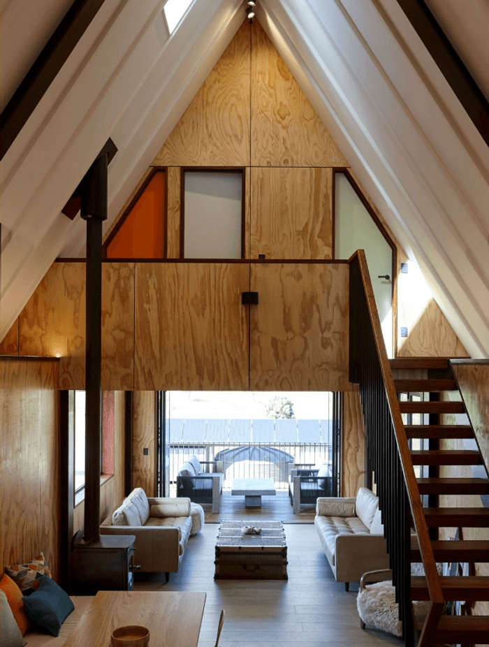 The ground floor living space leads out to a deck in the front, which is tucked under the deck space above, to crreate shelter and to extend the indoor space.