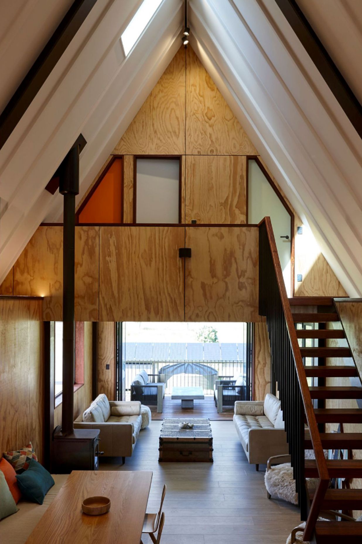 The ground floor living space leads out to a deck in the front, which is tucked under the deck space above, to crreate shelter and to extend the indoor space.