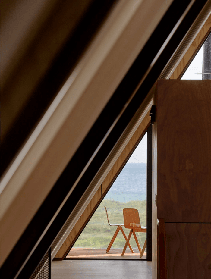 A sneak peak to the deck space behind the narrow guest bedrooms, which were conceived to be as compact as a boat's lodgings.