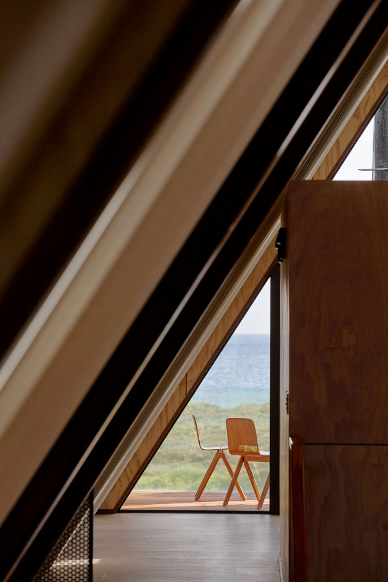 A sneak peak to the deck space behind the narrow guest bedrooms, which were conceived to be as compact as a boat's lodgings.