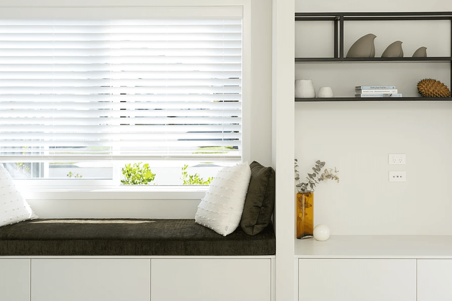 In this streamlined design the TV is hidden behind a sliding door.  The clients did not want the TV to be a focal point in the room, but at the same time wanted it positioned in a practical location.