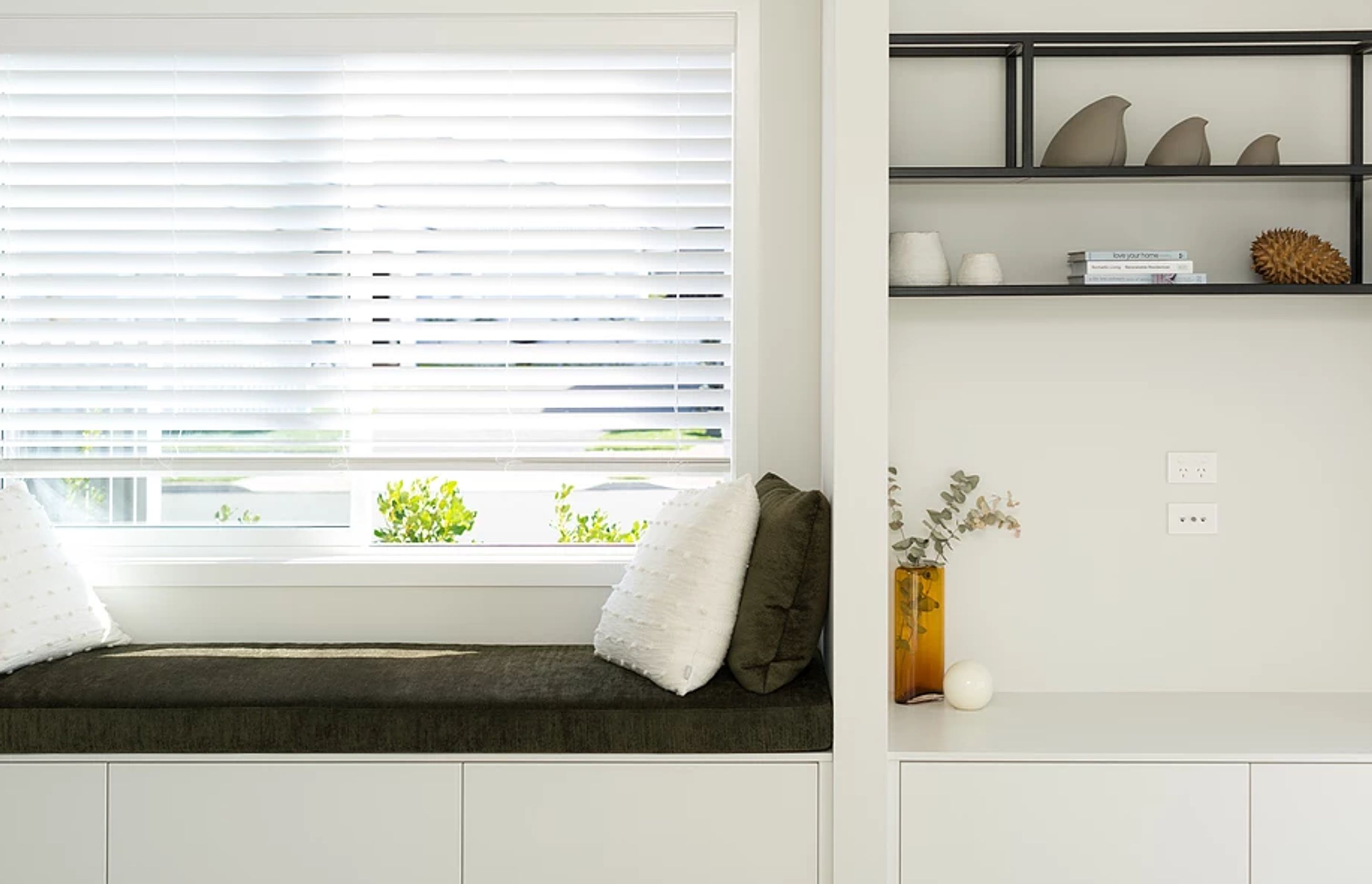 In this streamlined design the TV is hidden behind a sliding door. The clients did not want the TV to be a focal point in the room, but at the same time wanted it positioned in a practical location.